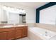 Bathroom with double sinks, large mirror, garden tub and separate shower at 5916 Tulip Flower Dr, Riverview, FL 33578