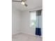 Bedroom with neutral carpet and decor and window with blue and gray curtains at 5916 Tulip Flower Dr, Riverview, FL 33578