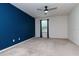 Bedroom with neutral carpet, blue accent wall, ceiling fan and lots of natural light at 5916 Tulip Flower Dr, Riverview, FL 33578