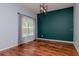 Dining room with hardwood floors, a window, and a modern light fixture at 5916 Tulip Flower Dr, Riverview, FL 33578