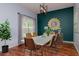 Bright dining room with hardwood floors, decorative wall art, and stylish furniture at 5916 Tulip Flower Dr, Riverview, FL 33578