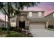 Two-story home featuring a front-facing two car garage and neutral color palette at 5916 Tulip Flower Dr, Riverview, FL 33578
