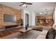 Spacious living room with a decorative wall, hardwood floors, and an open layout to the kitchen at 5916 Tulip Flower Dr, Riverview, FL 33578