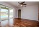 Open living room with hardwood floors and sliding door to pool area at 5916 Tulip Flower Dr, Riverview, FL 33578