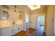 Elegant bar area with decorative backsplash, marble countertop, and hardwood floors at 608 Grove N St, St Petersburg, FL 33701