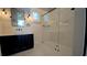 Modern bathroom featuring a walk-in shower with glass enclosure and black hardware at 608 Grove N St, St Petersburg, FL 33701