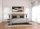 Comfortable bedroom with a tufted headboard, stylish lamps, and windows with lots of light at 608 Grove N St, St Petersburg, FL 33701