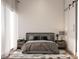 Modern bedroom featuring neutral colors, a minimalist bed frame, and a sliding barn door at 608 Grove N St, St Petersburg, FL 33701