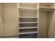 Organized closet with white shelving and hanging space, ideal for wardrobe storage at 608 Grove N St, St Petersburg, FL 33701