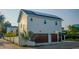 Exterior side view of a 2-story home with solar panels and a two-car garage at 608 Grove N St, St Petersburg, FL 33701