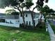 Two-story home featuring a charming side yard and lush green lawn at 608 Grove N St, St Petersburg, FL 33701