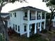 Elegant two-story home with a classic front porch, and lush greenery at 608 Grove N St, St Petersburg, FL 33701