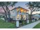 Two-story house boasts a large front porch and second story balcony, as well as a black iron fence at 608 Grove N St, St Petersburg, FL 33701