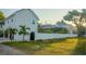 Exterior view of a home with mature trees and a screened in lanai at 608 Grove N St, St Petersburg, FL 33701