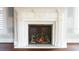 Beautiful fireplace with intricate detailing, flanked by windows and speaker system in the living room at 608 Grove N St, St Petersburg, FL 33701