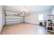Spacious two car garage with an epoxy floor, automatic door, and ladder at 608 Grove N St, St Petersburg, FL 33701