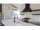 A well-lit kitchen features a stove, glass cabinetry, and open shelving at 608 Grove N St, St Petersburg, FL 33701