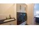 Convenient laundry room with modern washer and dryer units, sink, and cabinetry at 608 Grove N St, St Petersburg, FL 33701