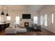 Bright living room with fireplace, television, white trim, hardwood floors and modern furniture at 608 Grove N St, St Petersburg, FL 33701