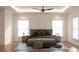 Spacious main bedroom with wood floors, ceiling fan, and natural light from the windows at 608 Grove N St, St Petersburg, FL 33701