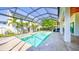 Screened in ground pool and hot tub, travertine tile deck, outdoor kitchen, white pillars and ceiling at 608 Grove N St, St Petersburg, FL 33701