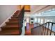 Beautiful hardwood staircase with iron railing overlooking the living room and fireplace at 608 Grove N St, St Petersburg, FL 33701