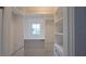 Bright walk-in closet with custom shelving, hanging racks, and a window for natural light at 608 Grove N St, St Petersburg, FL 33701