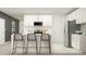 Modern kitchen featuring white cabinets, stainless steel appliances, and a breakfast bar area at 6394 Journey Way, New Port Richey, FL 34655