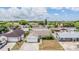 Aerial view of house in a residential neighborhood with tidy front yard and a driveway at 6908 Mesa Verde St, Port Richey, FL 34668