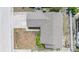 Aerial view of a home with a gray shingle roof and a small landscaped garden bed at 6908 Mesa Verde St, Port Richey, FL 34668