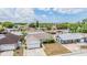Aerial view of the property situated in a residential neighborhood with green trees at 6908 Mesa Verde St, Port Richey, FL 34668