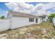 An exterior view of the backyard with white privacy fence at 6908 Mesa Verde St, Port Richey, FL 34668