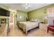 Comfortable bedroom featuring neutral tones, a ceiling fan, and a private bathroom entrance at 6908 Mesa Verde St, Port Richey, FL 34668