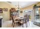 Elegant dining room featuring a classic wood table, chandelier, and sliding glass doors leading to the backyard at 6908 Mesa Verde St, Port Richey, FL 34668