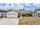 Charming single-story home with a well-maintained lawn, attached garage, and inviting yellow front door at 6908 Mesa Verde St, Port Richey, FL 34668