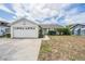 Exterior shot of home with two car garage and tidy front yard at 6908 Mesa Verde St, Port Richey, FL 34668