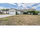 Front exterior of house, showing landscaped yard, driveway, and a garage at 6908 Mesa Verde St, Port Richey, FL 34668