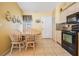 Bright kitchen with granite countertops, tile flooring, and breakfast nook with table for 4 at 6908 Mesa Verde St, Port Richey, FL 34668