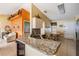 Open kitchen area with granite countertops, breakfast bar, and a view into the adjacent living space at 6908 Mesa Verde St, Port Richey, FL 34668