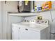 Laundry area with white washer and dryer and shelving at 6908 Mesa Verde St, Port Richey, FL 34668