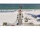 A scenic aerial view shows a crowded beach with a pier and many recreational activities at 701 S Madison Ave # 505, Clearwater, FL 33756
