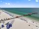 A scenic aerial view highlights the shoreline and pier along a beach with water activities at 701 S Madison Ave # 505, Clearwater, FL 33756