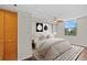 Bright bedroom with natural light features wood-look flooring, neutral paint and walk-in closet at 701 S Madison Ave # 505, Clearwater, FL 33756