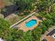 Aerial view of a private pool surrounded by lush greenery and mature trees at 701 S Madison Ave # 505, Clearwater, FL 33756