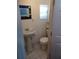 Cozy bathroom with a pedestal sink, mirror, and toilet next to the shower at 703/709 Patterson St, Clearwater, FL 33756