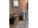 Simple bathroom with a pedestal sink, toilet, and potted plant at 703/709 Patterson St, Clearwater, FL 33756