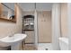 Bathroom featuring a vanity sink, mirror, towel rack and walk-in shower with tiled surround at 703/709 Patterson St, Clearwater, FL 33756
