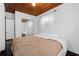 Bright bedroom with wood ceiling, light walls, mirrored closet, and a comfortable bed at 703/709 Patterson St, Clearwater, FL 33756