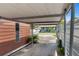 Carport showing the side of a house, driveway, boat, and the front of a house across the street at 703/709 Patterson St, Clearwater, FL 33756