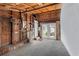Spacious unfinished garage with an exposed ceiling, water heater, and French doors to the yard at 703/709 Patterson St, Clearwater, FL 33756